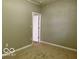 Empty bedroom featuring carpet, neutral walls and a doorway at 6373 E Hadley Rd, Mooresville, IN 46158