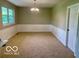 Spacious dining area with wainscoting and large windows at 6373 E Hadley Rd, Mooresville, IN 46158
