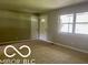 Living room with carpet and entry door at 6373 E Hadley Rd, Mooresville, IN 46158
