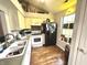 Well-lit kitchen features white cabinets, modern appliances, and hardwood floors at 6640 Sundown S Dr, Indianapolis, IN 46254
