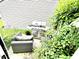 Backyard patio with grill, seating, and lush green plants, perfect for outdoor relaxation at 6640 Sundown S Dr, Indianapolis, IN 46254