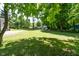 Spacious backyard with expansive lawn, mature trees, and a shed at 6799 Lakeshore Dr, Avon, IN 46123