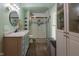 This full bathroom boasts a stand up shower, wood look flooring and a modern color palette at 6799 Lakeshore Dr, Avon, IN 46123