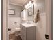Charming bathroom featuring modern vanity, wainscoting, decorative mirror, and updated fixtures at 6799 Lakeshore Dr, Avon, IN 46123