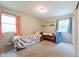 This bedroom includes two beds, great natural light, and a whimsical color palette at 6799 Lakeshore Dr, Avon, IN 46123