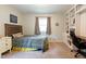 Cozy bedroom with a built-in bookcase and desk area providing plenty of storage and work space at 6799 Lakeshore Dr, Avon, IN 46123