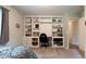 Bedroom featuring a built-in bookcase, desk area, and neutral carpet with natural light from the window at 6799 Lakeshore Dr, Avon, IN 46123