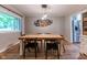 Elegant dining room featuring a wooden table with black chairs and stylish light fixture at 6799 Lakeshore Dr, Avon, IN 46123
