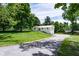 Charming home featuring a well-maintained front yard and a long driveway framed by mature trees at 6799 Lakeshore Dr, Avon, IN 46123
