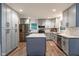 Modern kitchen featuring gray cabinets, stainless steel appliances, and a center island at 6799 Lakeshore Dr, Avon, IN 46123