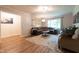 Comfortable living room with large windows, a sectional sofa, and wood-look flooring at 6799 Lakeshore Dr, Avon, IN 46123
