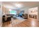 Inviting living room featuring hardwood floors, a large window, and stylish furnishings at 6799 Lakeshore Dr, Avon, IN 46123