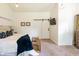 This main bedroom features neutral tones, a barn door, and an eye-catching geometric light fixture at 6799 Lakeshore Dr, Avon, IN 46123