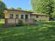 Backyard with a wood lattice fence and lush green space that provides plenty of room for outdoor activities at 7015 Westlake Rd, Indianapolis, IN 46214