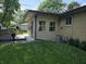 Backyard featuring a well-maintained deck, sunroom, and lawn at 7015 Westlake Rd, Indianapolis, IN 46214