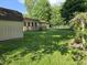 A large, well-maintained backyard with a deck, outbuilding, and a garden area at 7015 Westlake Rd, Indianapolis, IN 46214