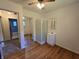 Bedroom boasts hardwood floors, bathroom, mirrored closet doors, and window for natural light at 7015 Westlake Rd, Indianapolis, IN 46214