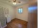 A charming bedroom includes a private bathroom, window for natural light and hardwood floors at 7015 Westlake Rd, Indianapolis, IN 46214