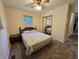 Bedroom features a comfortable bed, mirrored closet doors and a window for natural light at 7015 Westlake Rd, Indianapolis, IN 46214