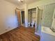 Hardwood-floored bedroom features a private bathroom, shower stall, and mirrored closet doors at 7015 Westlake Rd, Indianapolis, IN 46214