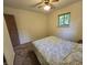 A cozy bedroom features a comfortable bed, window for natural light and a ceiling fan at 7015 Westlake Rd, Indianapolis, IN 46214