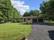 Charming single-story home featuring a well-maintained lawn, mature trees, and an inviting driveway at 7015 Westlake Rd, Indianapolis, IN 46214