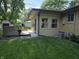 Well-maintained exterior of home with a deck and sunroom extension at 7015 Westlake Rd, Indianapolis, IN 46214