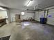 Well-lit garage featuring functional space, overhead doors, and built-in storage for practical organization at 7015 Westlake Rd, Indianapolis, IN 46214