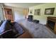 Carpeted living room with a fireplace and a large window that brings in tons of natural light at 7015 Westlake Rd, Indianapolis, IN 46214