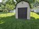 Backyard shed provides additional storage space and complements the lush green lawn at 7015 Westlake Rd, Indianapolis, IN 46214