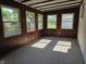 Well-lit sun room featuring carpet and wood paneled walls at 7015 Westlake Rd, Indianapolis, IN 46214