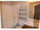 Bright bathroom featuring a shower-tub, mirrored vanity, and storage shelving unit at 708 Mountain Pine Dr, Greenwood, IN 46143