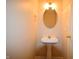 Powder room with pedestal sink, oval mirror, and neutral wall color at 708 Mountain Pine Dr, Greenwood, IN 46143