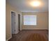 Bedroom with neutral walls, carpet, closet, window with blinds, and overhead lighting at 708 Mountain Pine Dr, Greenwood, IN 46143