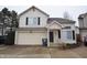 Two story home with neutral siding, two car garage and black shutters at 708 Mountain Pine Dr, Greenwood, IN 46143