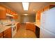 Open concept kitchen with wood cabinets, tile flooring, and a view into the living area at 708 Mountain Pine Dr, Greenwood, IN 46143