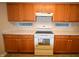 Traditional kitchen showcasing wood cabinets, neutral countertops, and a white range at 708 Mountain Pine Dr, Greenwood, IN 46143