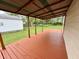 Inviting covered back porch with stained wood and view of backyard at 710 Bacon St, Indianapolis, IN 46227