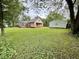 Lush backyard with a well-maintained lawn, highlighted by a cozy deck and a detached garage at 710 Bacon St, Indianapolis, IN 46227