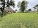 Large backyard featuring a well-maintained lawn, offering ample space and a detached garage at 710 Bacon St, Indianapolis, IN 46227