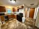 Functional kitchen with wood cabinets and linoleum floor at 710 Bacon St, Indianapolis, IN 46227