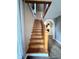 Wooden staircase with carpet and handrail leading to the upper level at 710 Bacon St, Indianapolis, IN 46227