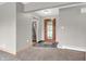 Neutral color entryway featuring a stained glass door and view into the kitchen at 7380 N State Road 267, Brownsburg, IN 46112
