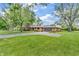 Wide view of a brick house featuring a paved driveway and well-maintained landscaping at 7380 N State Road 267, Brownsburg, IN 46112