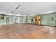 Garage with hardwood floors, painted walls, and access to additional storage space at 7380 N State Road 267, Brownsburg, IN 46112