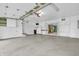 Spacious garage with white walls, concrete floor, storage cabinets, and overhead lighting at 7380 N State Road 267, Brownsburg, IN 46112