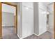 Hallway with carpeted floor, white storage closets, and entrances to other rooms at 7380 N State Road 267, Brownsburg, IN 46112
