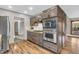 Gourmet kitchen featuring modern appliances, custom cabinetry, and a stone accent wall at 7380 N State Road 267, Brownsburg, IN 46112