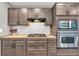 Close up of a modern kitchen featuring stainless appliances, custom backsplash and modern gas cooktop at 7380 N State Road 267, Brownsburg, IN 46112
