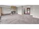 Open-concept living area with fireplace, new carpet, and easy access to other rooms at 7380 N State Road 267, Brownsburg, IN 46112